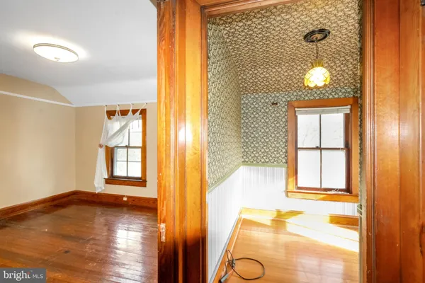 a view of an entryway with wooden floor and staircase