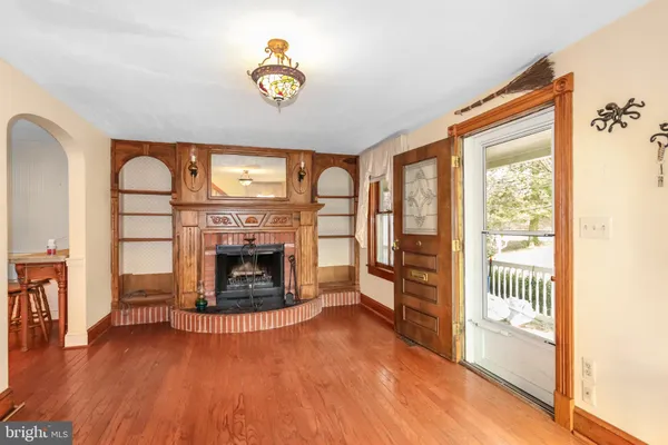 a living room with furniture a fireplace and large windows