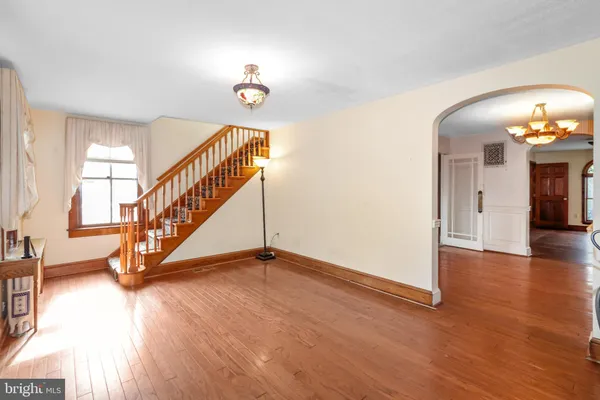 a view of a livingroom with wooden floor and a window