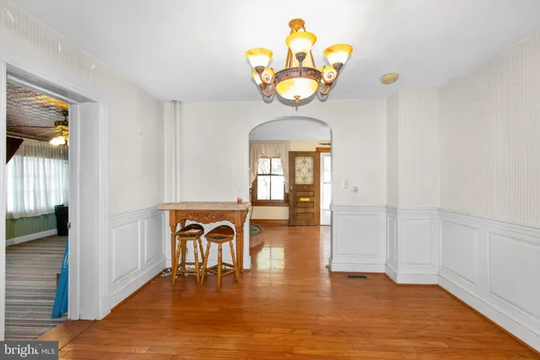 a large kitchen with stainless steel appliances granite countertop a refrigerator a stove and a sink