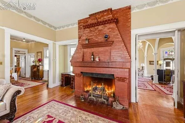 a living room with furniture and a chandelier