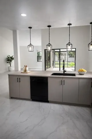a kitchen with a sink and cabinets