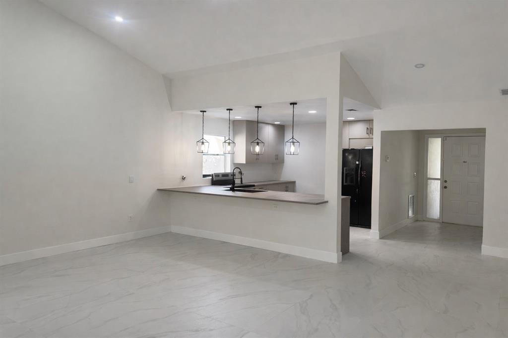 20835 Vía Madeira, Unit 6115 Boca Raton, FL 33433 - Photo 2 of 5 a view of a kitchen with refrigerator and a sink