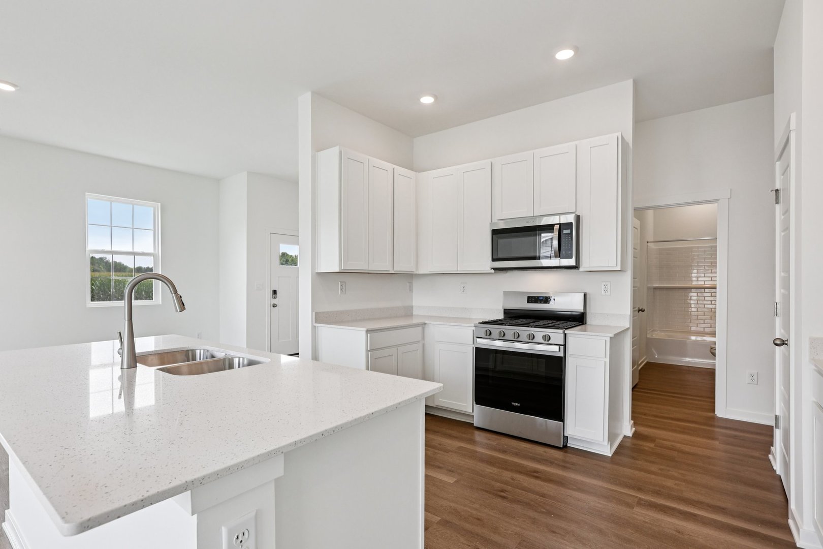 6481 Juniper Drive Wonder Lake, IL 60097 - Photo 11 of 59 a kitchen with granite countertop white cabinets and stainless steel appliances