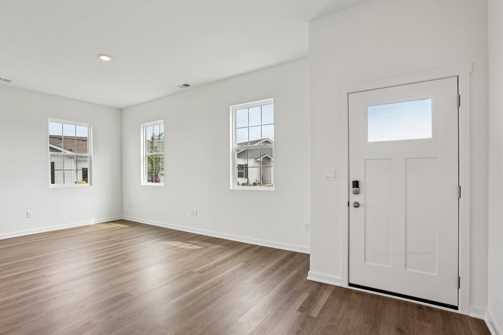 6481 Juniper Drive Wonder Lake, IL 60097 - Photo 3 of 59 a view of an empty room with wooden floor and a window