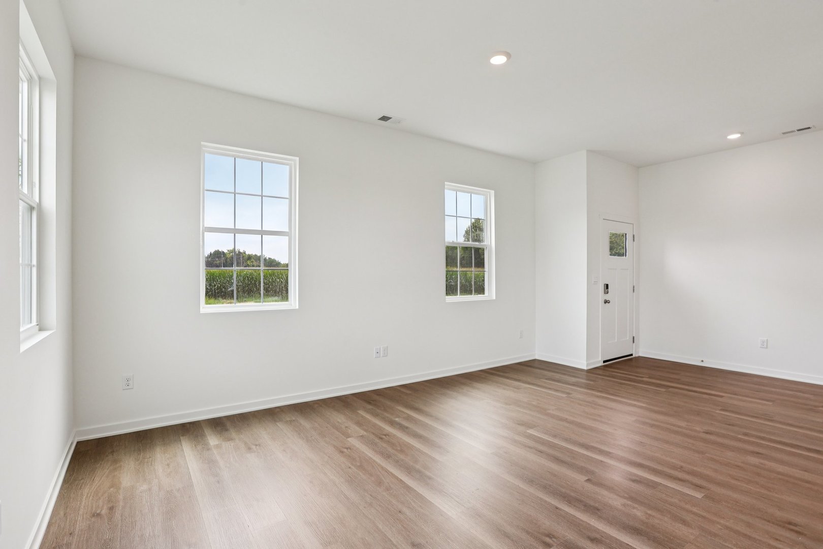 6481 Juniper Drive Wonder Lake, IL 60097 - Photo 6 of 59 an empty room with wooden floor and windows
