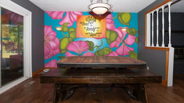 a room that has a table chair and a wooden floor