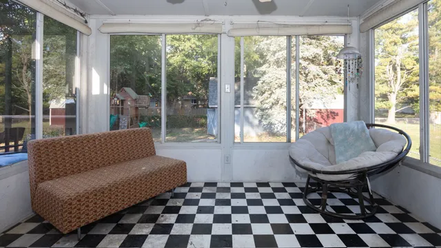 a living room with a black white checkered floor and a table