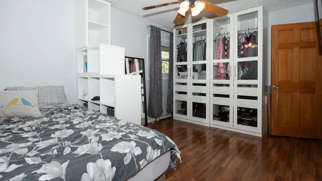 a bedroom with a bed and wooden floor