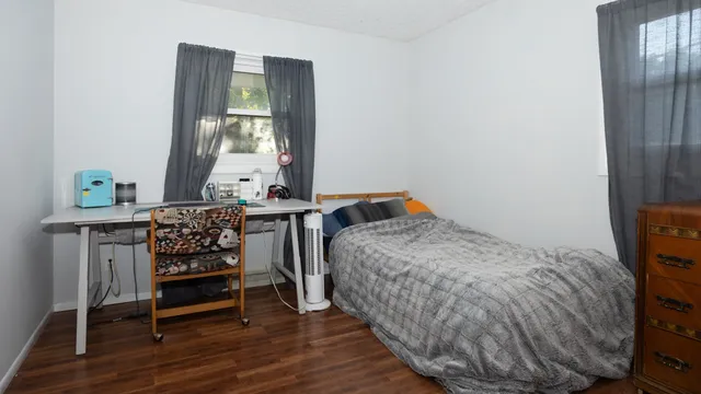 a bedroom with a bed and a window