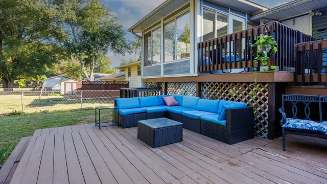 a view of a deck with couches and wooden floor