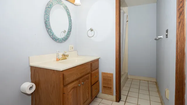 a bathroom with a sink mirror and vanity