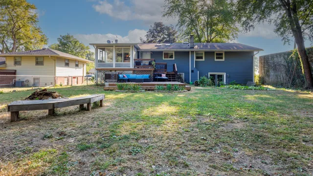 a backyard of a house with yard and outdoor seating