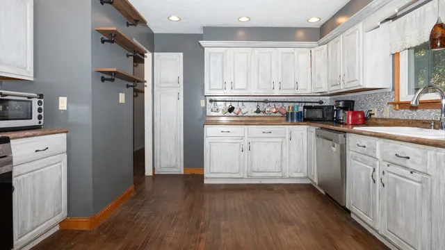 a kitchen with stainless steel appliances a refrigerator sink and cabinets