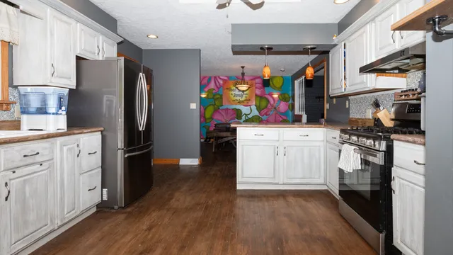 a kitchen with stainless steel appliances a refrigerator sink and stove