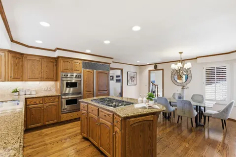 a kitchen with stainless steel appliances granite countertop a stove and a refrigerator
