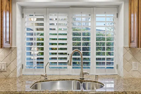 a kitchen with a sink and a large window