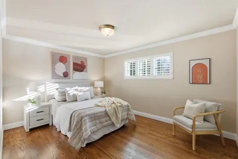 a bedroom with a bed and a chair