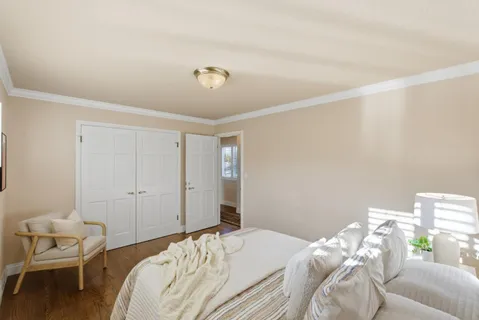 a bedroom with a bed and a chair