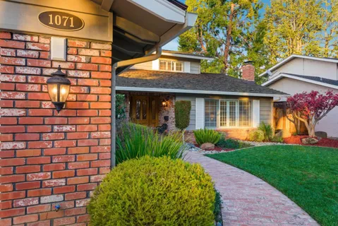 a front view of a house with garden