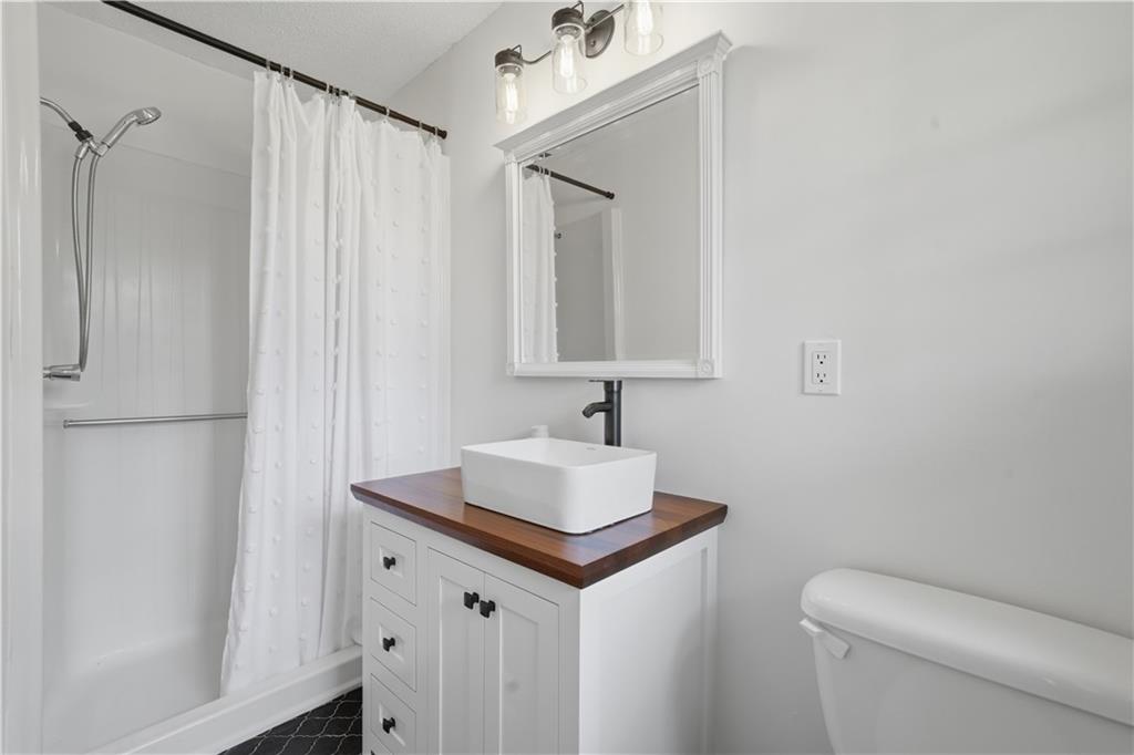 125 Childers Road Canton, GA 30115 - Photo 36 of 48 a bathroom with a sink toilet and shower