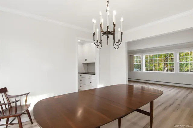 a view of a dining room with furniture and chandelier
