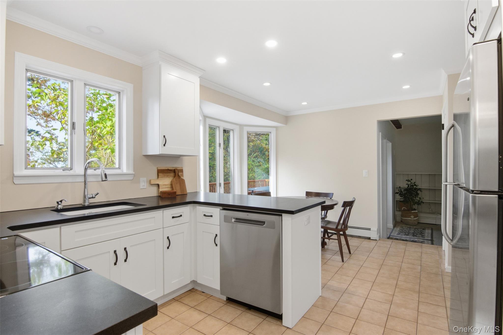 14 Flax Pond Woods Road Setauket, NY 11733 - Photo 12 of 41 a kitchen with a sink and cabinets