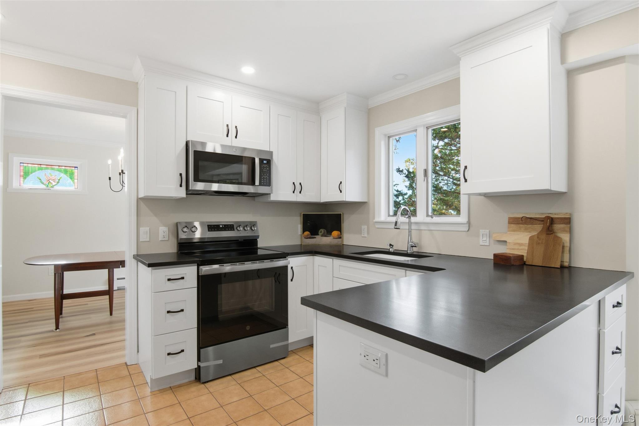 14 Flax Pond Woods Road Setauket, NY 11733 - Photo 13 of 41 a kitchen with granite countertop a stove sink and microwave