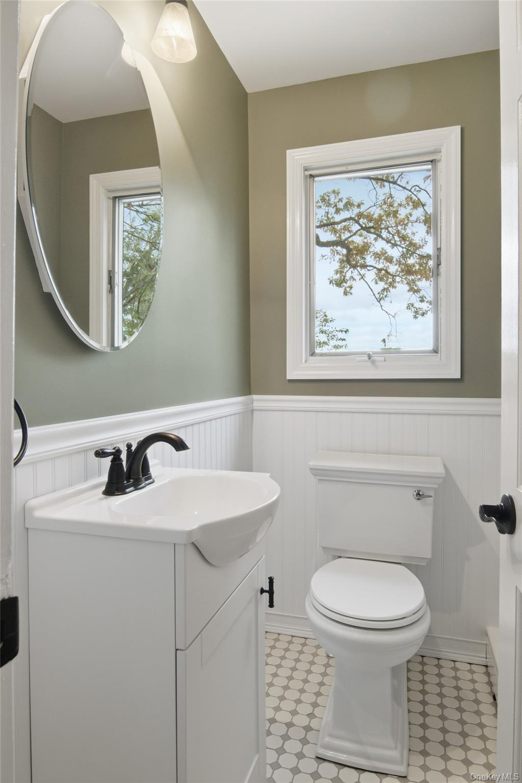 14 Flax Pond Woods Road Setauket, NY 11733 - Photo 25 of 41 a bathroom with a toilet a sink and mirror