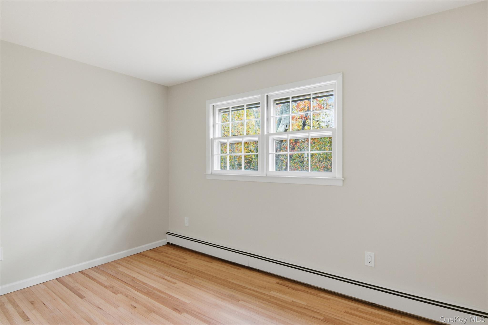 14 Flax Pond Woods Road Setauket, NY 11733 - Photo 29 of 41 wooden floor in an empty room with a window