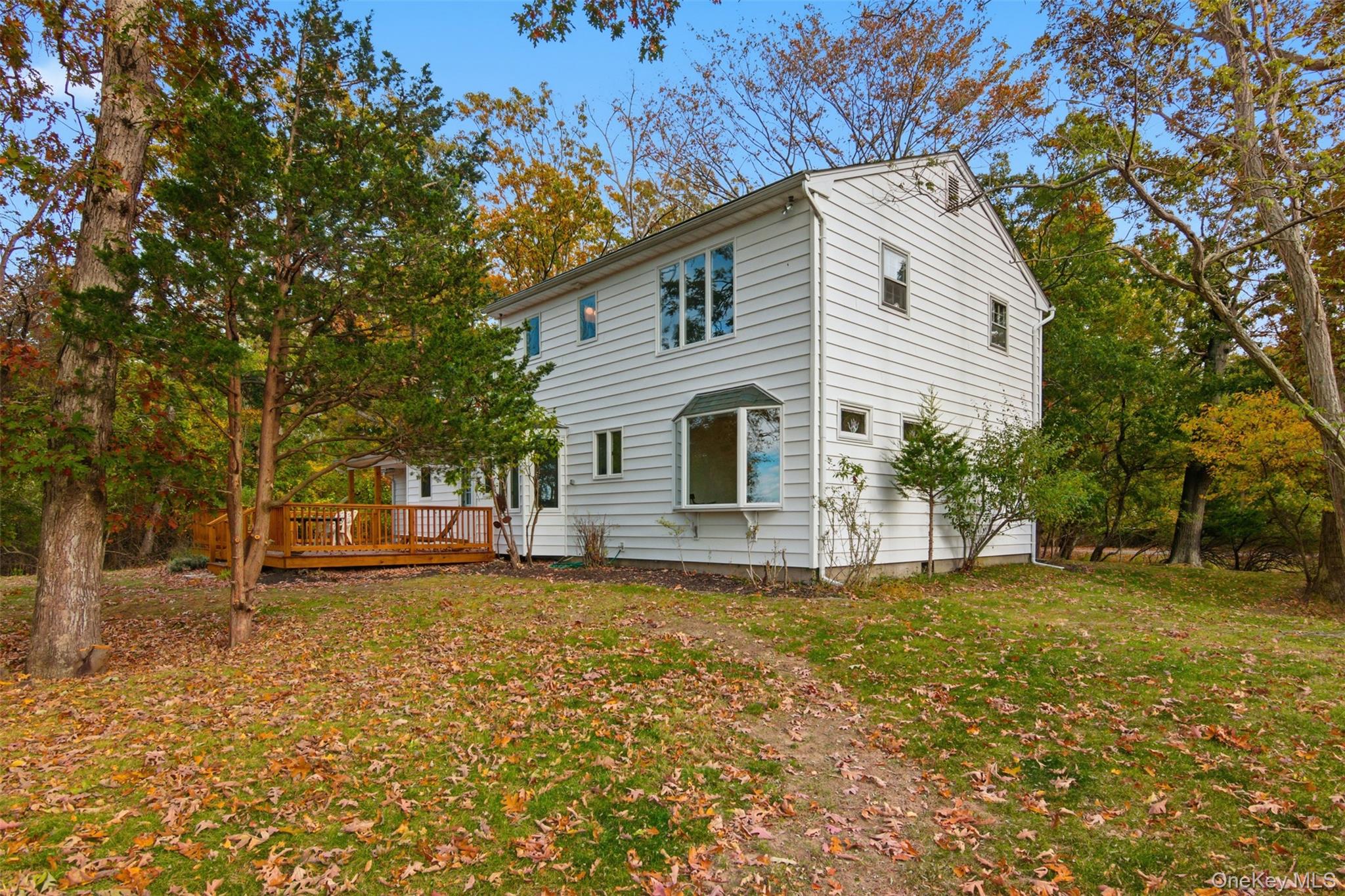 14 Flax Pond Woods Road Setauket, NY 11733 - Photo 38 of 41 a view of a house with a yard