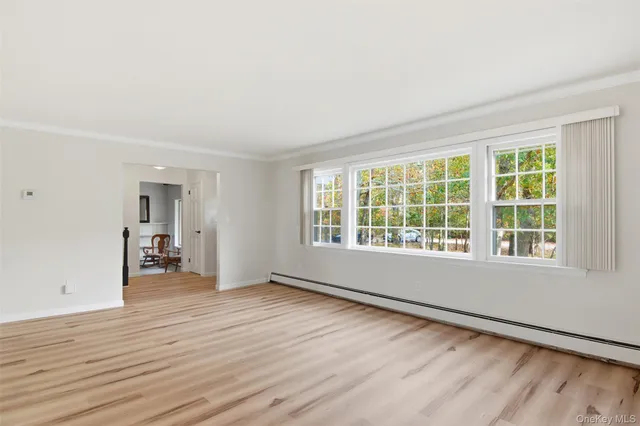 wooden floor in an empty room with a window