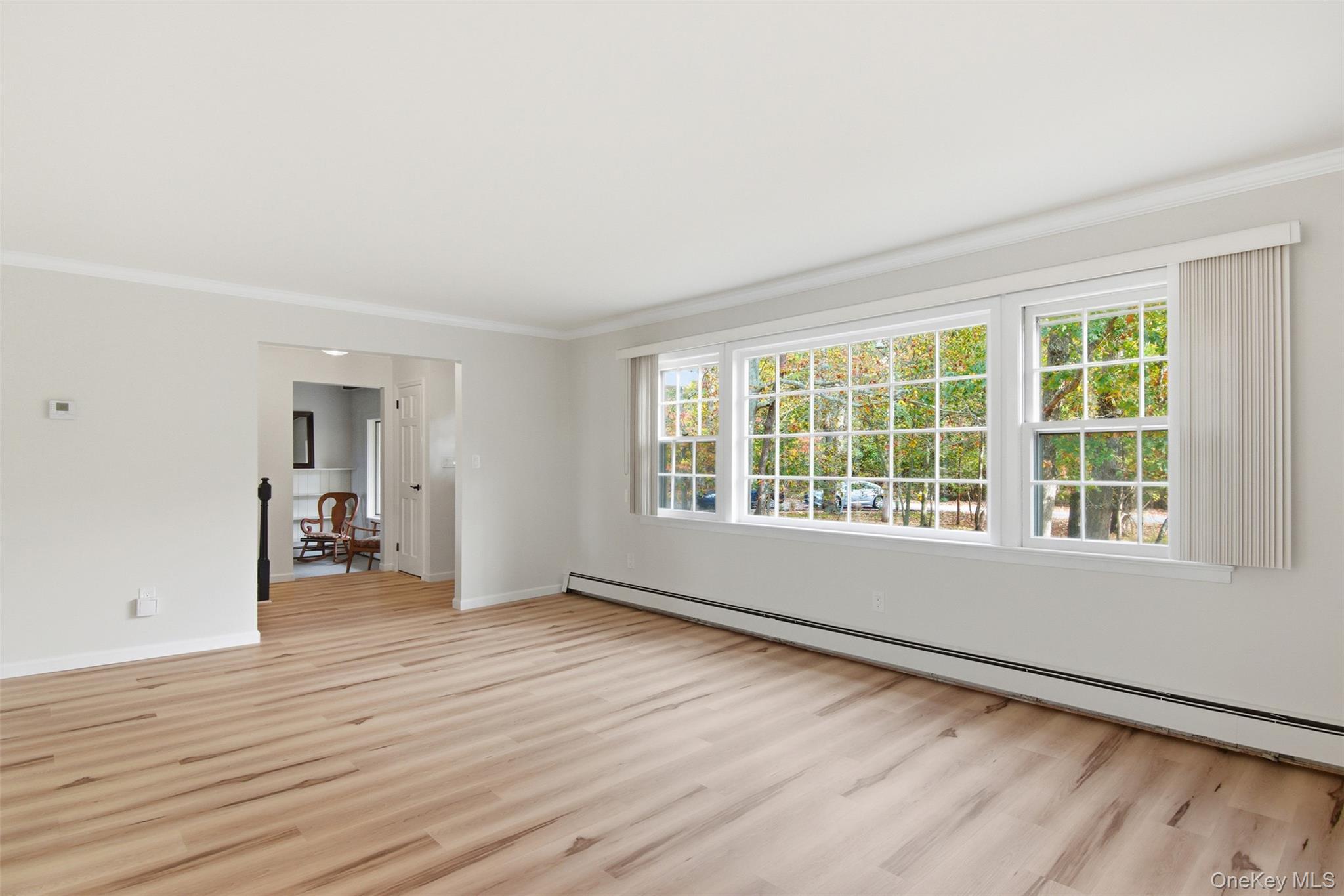 14 Flax Pond Woods Road Setauket, NY 11733 - Photo 7 of 41 wooden floor in an empty room with a window