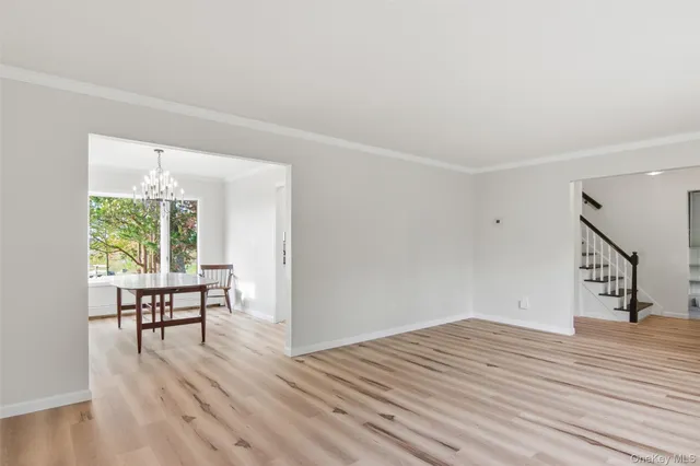 a view of a livingroom with wooden floor and a floor to ceiling window