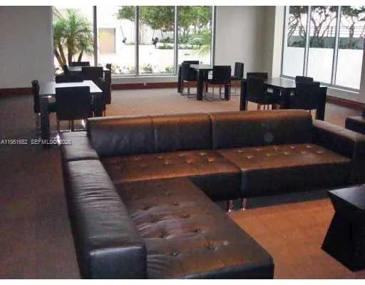 a bedroom with furniture and large windows