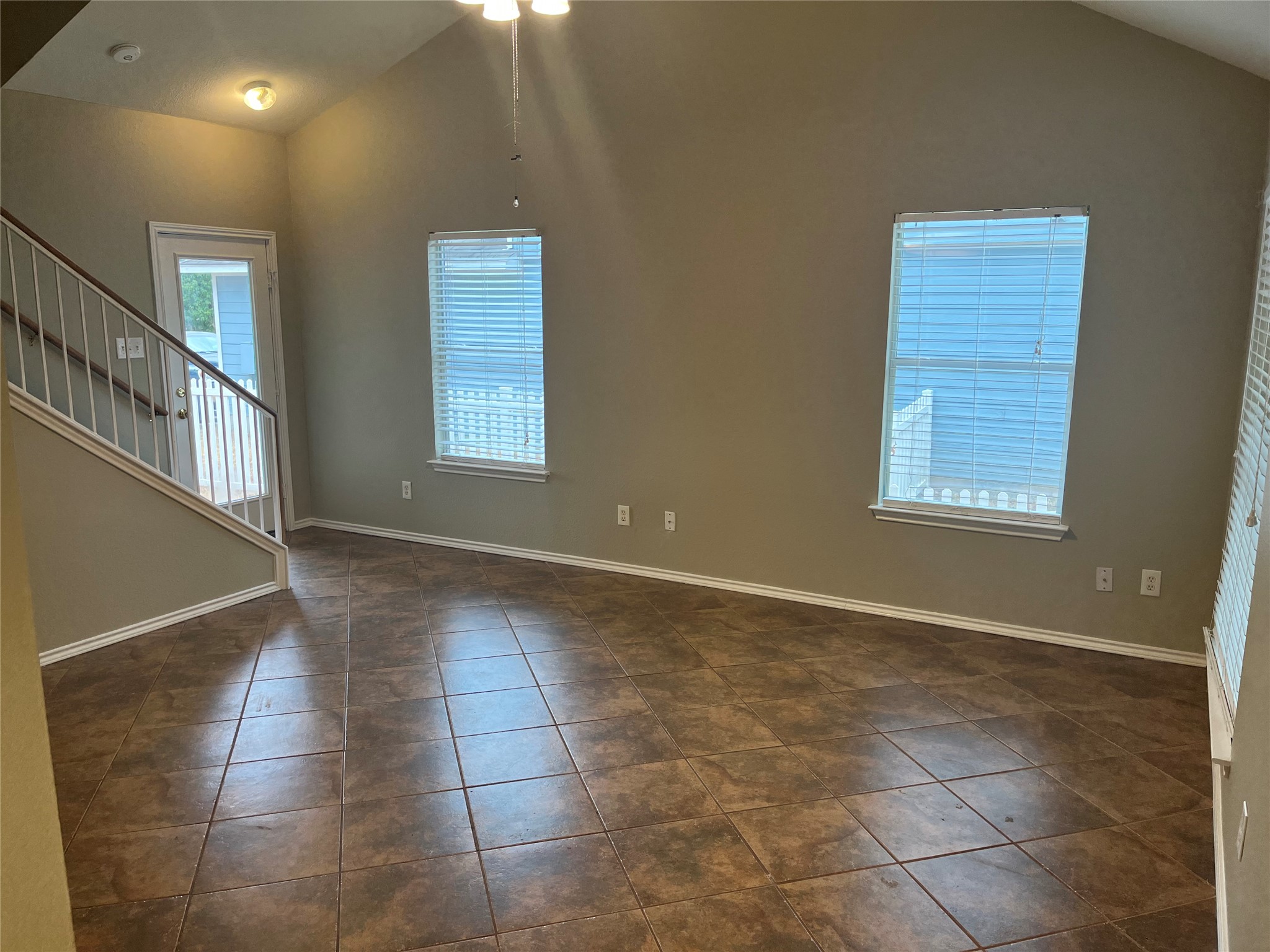 694 Hogan Kyle, TX 78640 - Photo 18 of 20 Empty room with lofted ceiling and dark tile patterned flooring