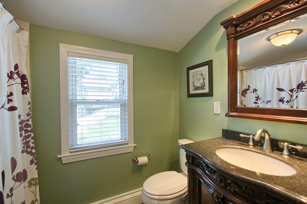 29 Spring Street Wakefield, MA 01880 - Photo 13 of 30 a bathroom with a granite countertop toilet sink and mirror