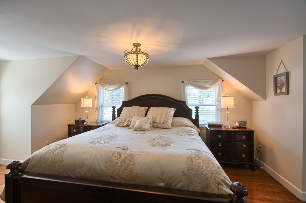 29 Spring Street Wakefield, MA 01880 - Photo 14 of 30 a bedroom with a bed and a mirror