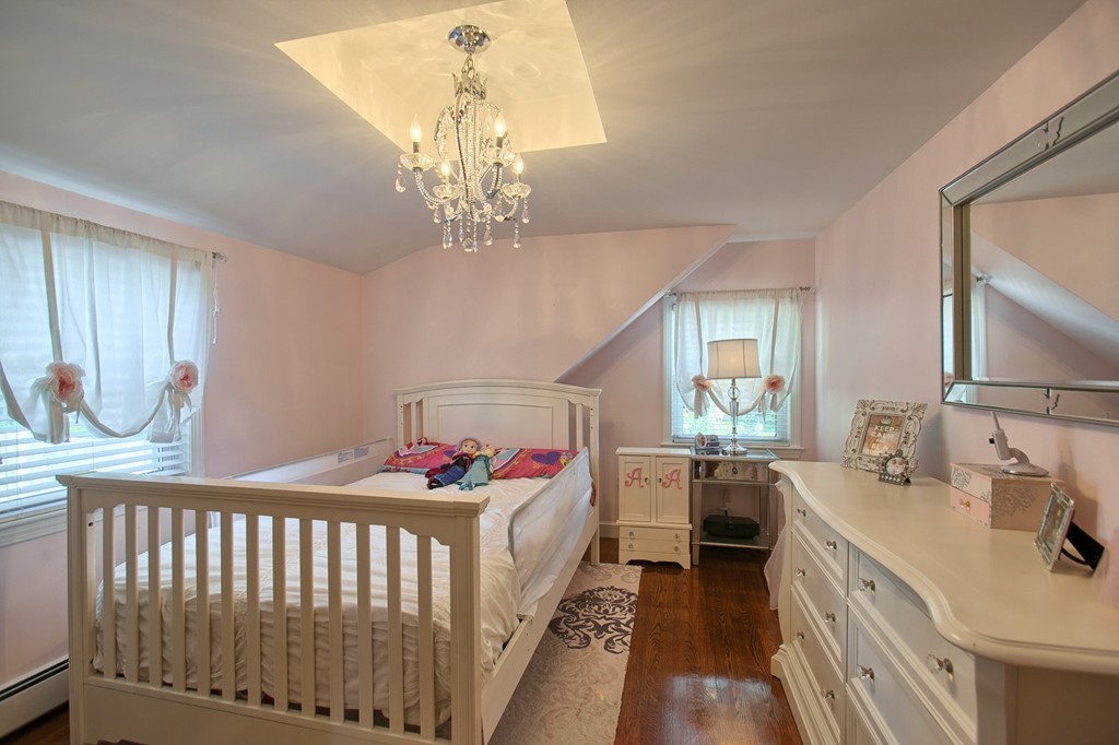 29 Spring Street Wakefield, MA 01880 - Photo 17 of 30 a bed room with a bed and a chandelier