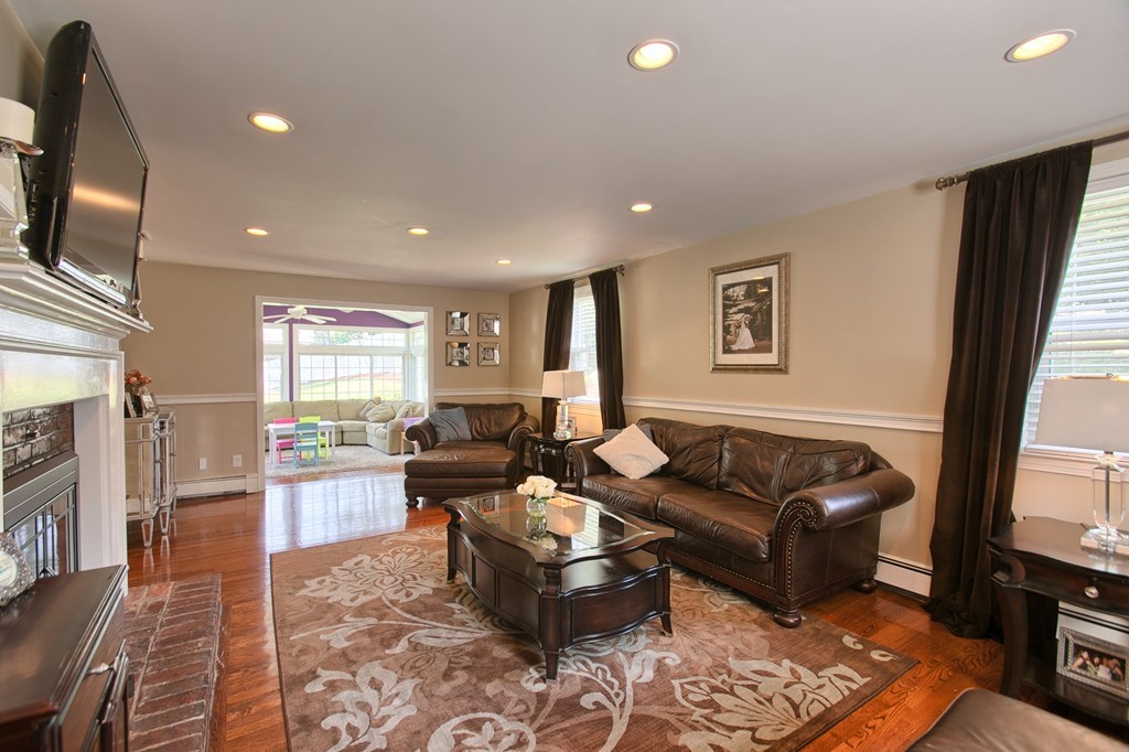 29 Spring Street Wakefield, MA 01880 - Photo 4 of 30 a living room with furniture fireplace and a flat screen tv