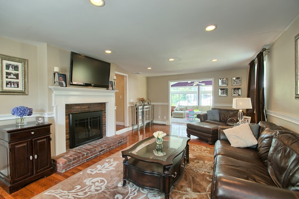 29 Spring Street Wakefield, MA 01880 - Photo 5 of 30 a living room with furniture a flat screen tv and a fireplace