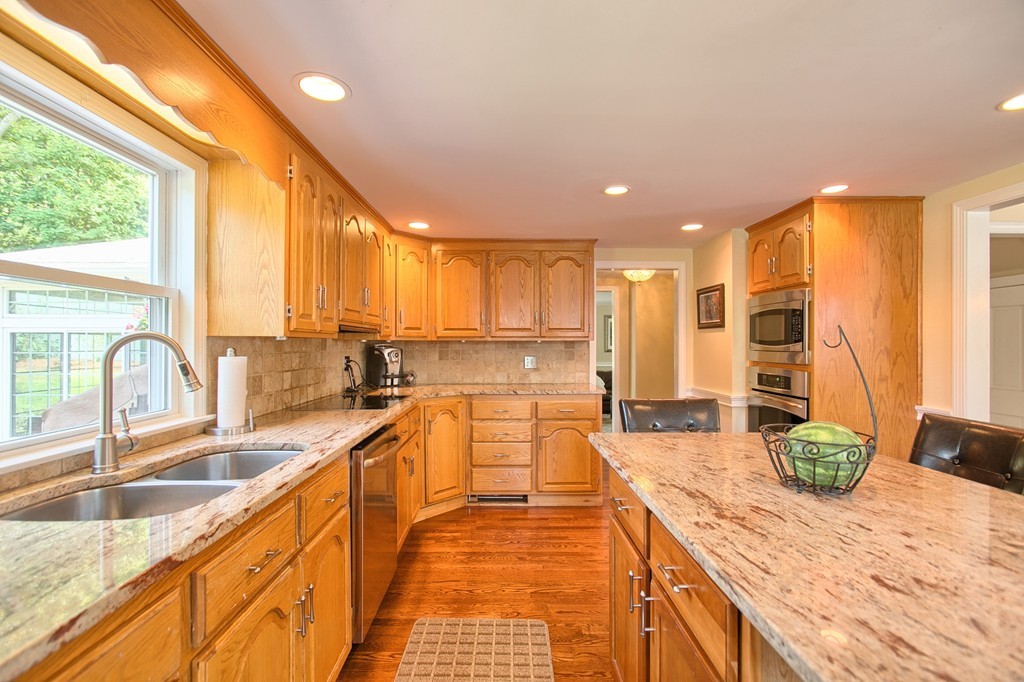 29 Spring Street Wakefield, MA 01880 - Photo 9 of 30 a large kitchen with kitchen island granite countertop a large counter top stainless steel appliances a sink and cabinets