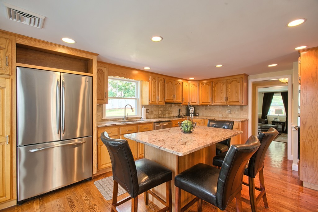 29 Spring Street Wakefield, MA 01880 - Photo 10 of 30 a kitchen with a refrigerator a dining table and chairs