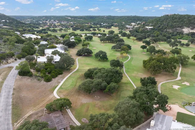 an aerial view of a house with outdoor space pool seating area and fire pit