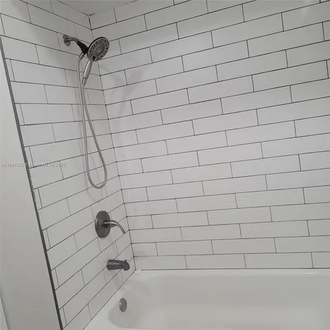 a bathroom with a granite countertop toilet and a sink