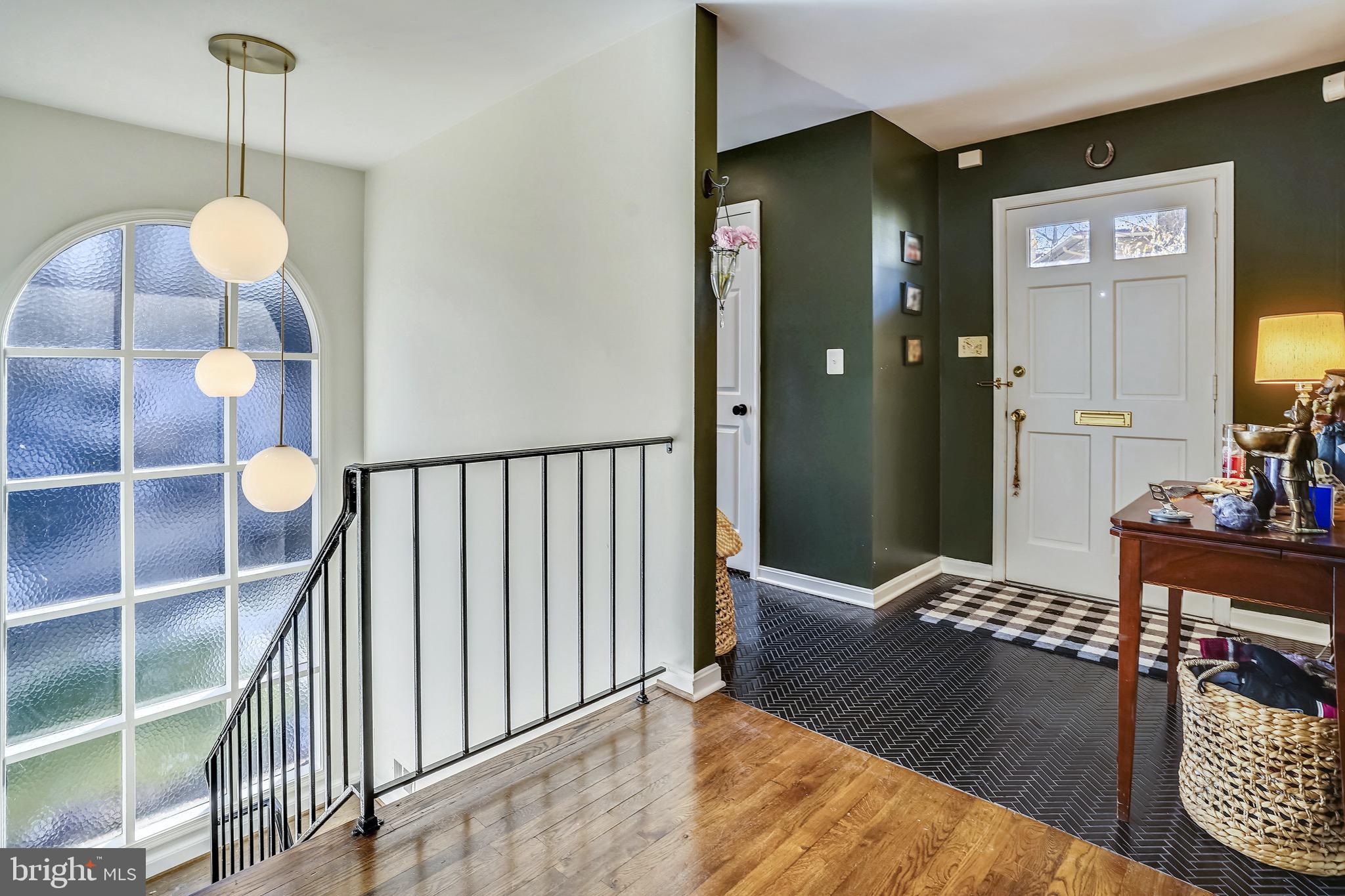 View of front door and brightly lit entryway