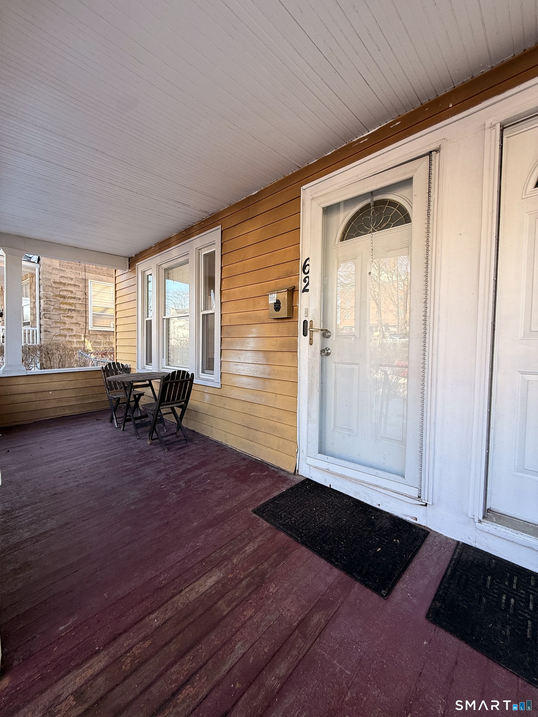 62 Putnam Street Meriden, CT 06450 - Photo 2 of 7 a view of a livingroom with furniture hardwood floor and hallway