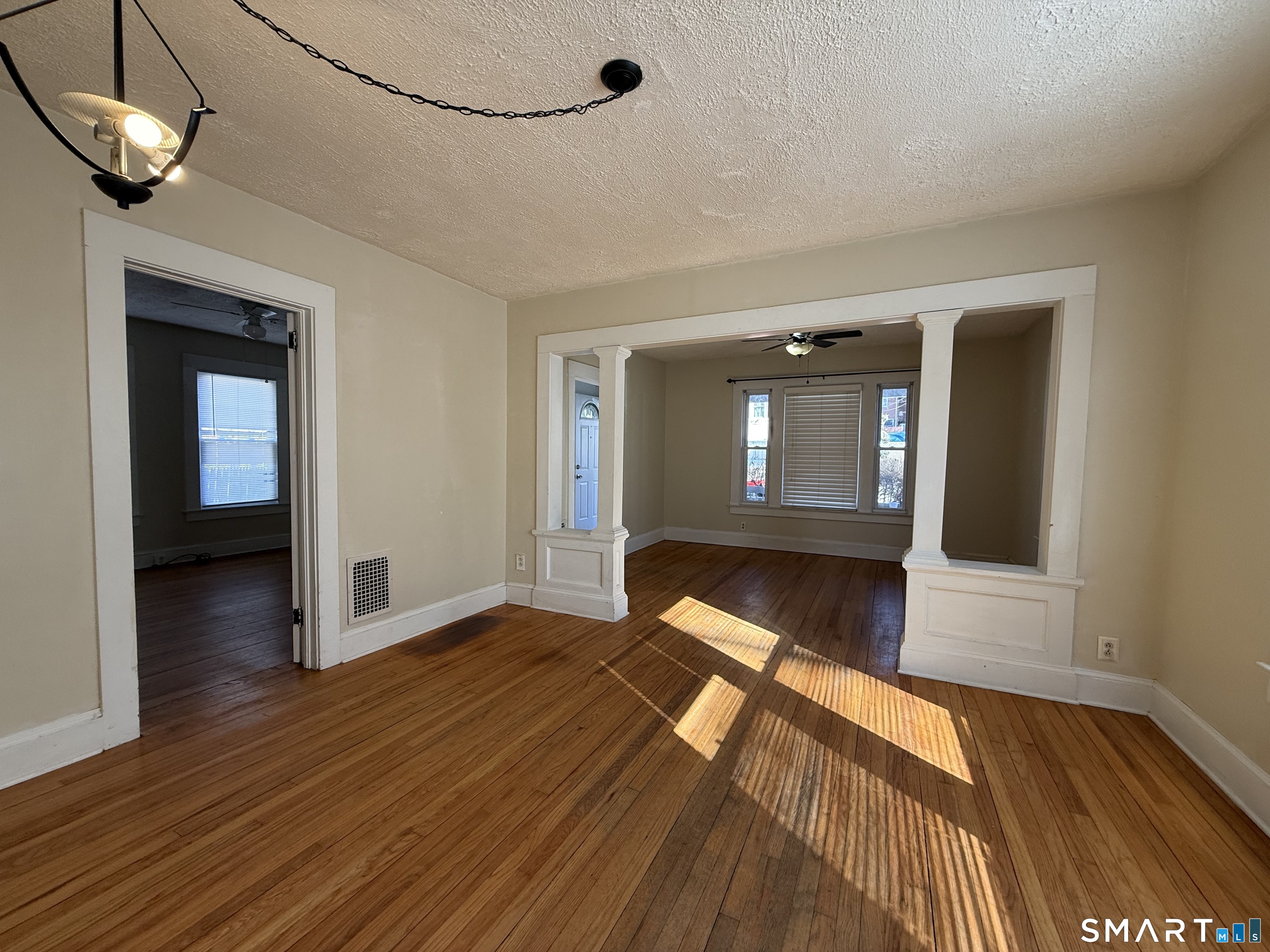 62 Putnam Street Meriden, CT 06450 - Photo 3 of 7 wooden floor in an empty room with a window