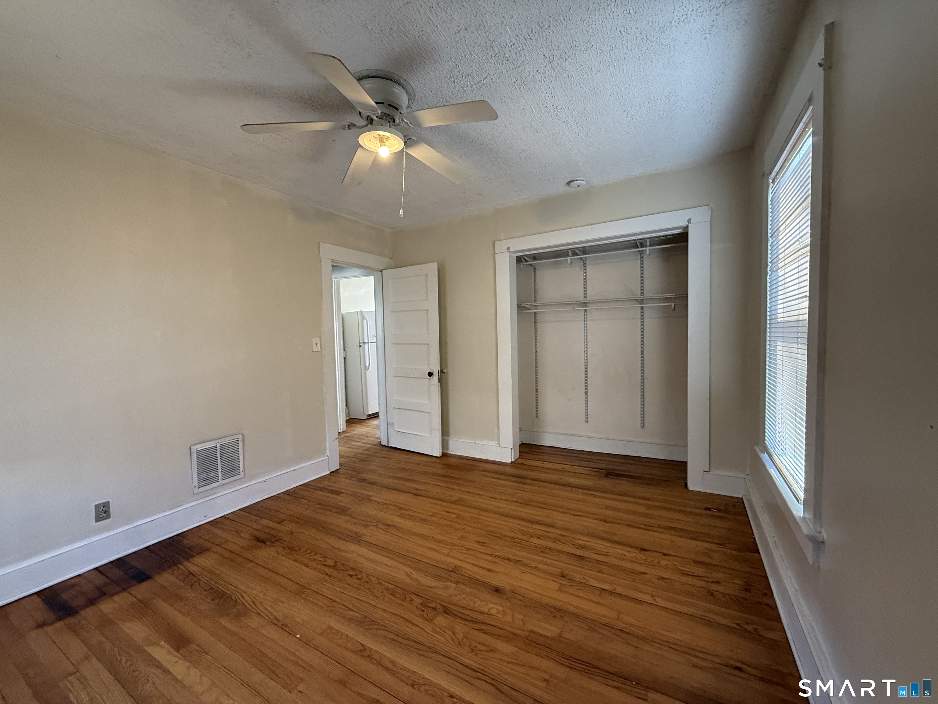 62 Putnam Street Meriden, CT 06450 - Photo 7 of 7 a view of an empty room with wooden floor and a window