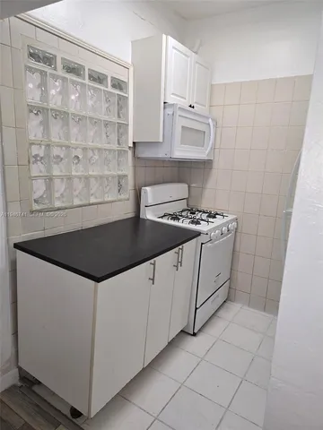 a kitchen with granite countertop a sink and a stove